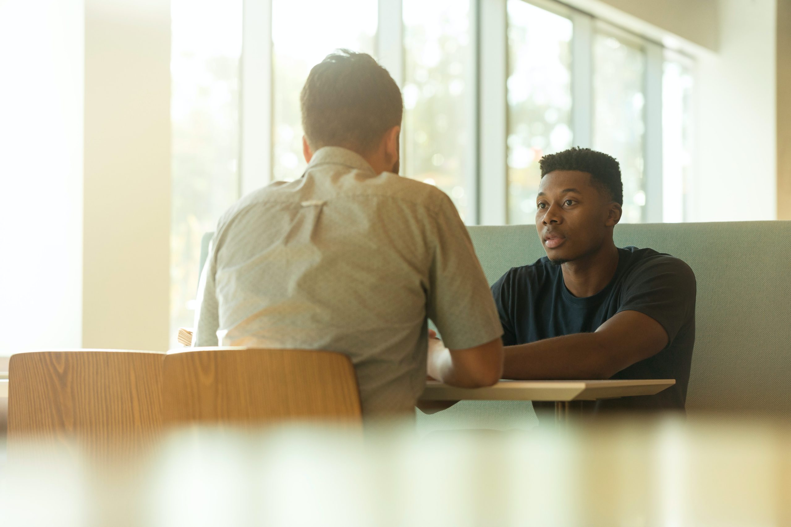 Black employee in a meeting with a white manager